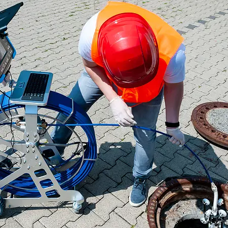 Application of the push cable on trolley with a drain inspection camera.